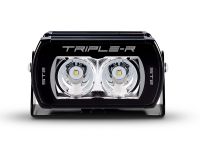 Front view of the lamp face showing the lens and central light source, with the housing and bezel clearly visible.